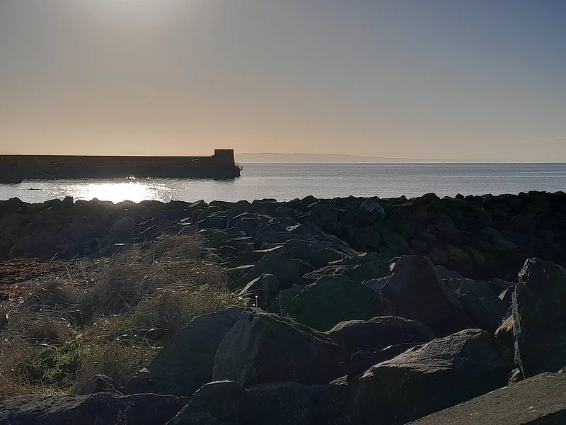 Saltcoats harbour silhouetted in the sun