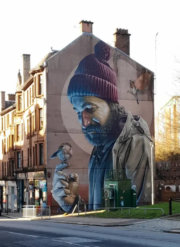 Mural Mural on Glasgow terrace end of a man with sparrow